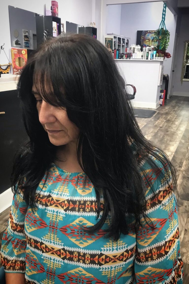 A portrait of a woman with long, layered, and tousled shag hair, capturing the softness and modern elegance of the trend