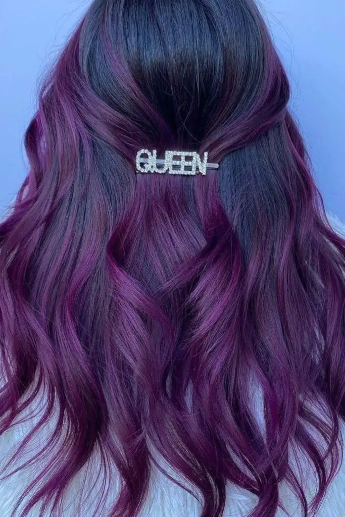 Dark hair with streaks of deep plum.