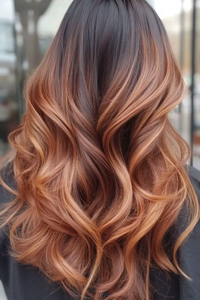 Dark roots transitioning into copper tips.