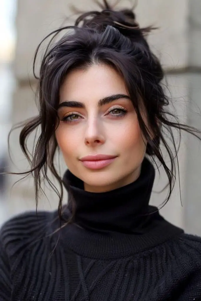 Loose updo with romantic tendrils.