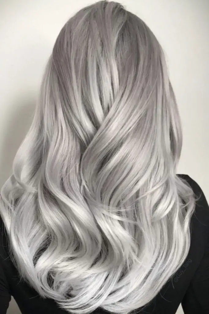 Smoky lowlights shimmer in silver hair.