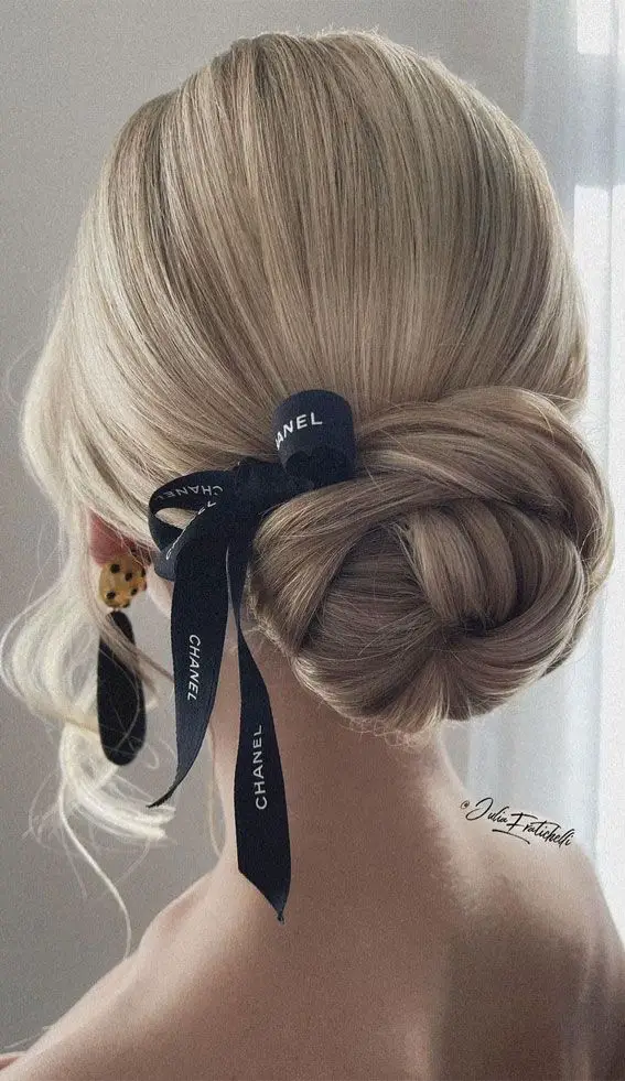 Charming twisted bow bun offers a playful twist on classic styles.