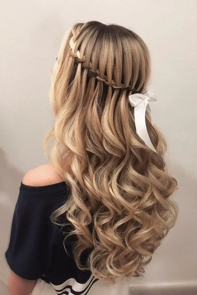 Cascading waterfall braid adding ethereal charm.