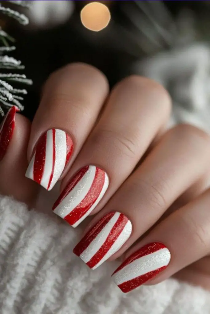 Festive red nails with white swirls.