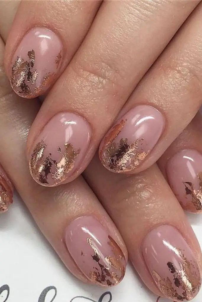 "Minimalist nails with golden foil tips."
