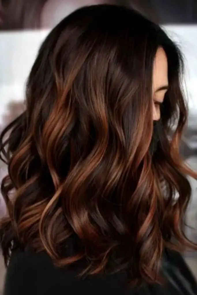 Copper streaks on warm chocolate balayage.