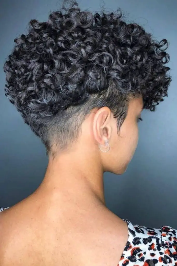 Curly, high-volume mushroom cut at crown.
