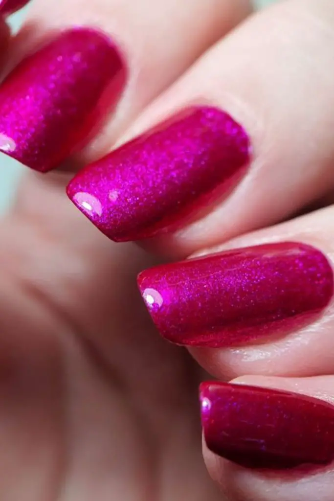 "Vivid magenta nails with subtle sparkle."