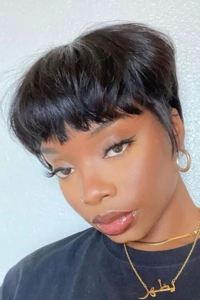 Minimalist mushroom cut with soft fringe.