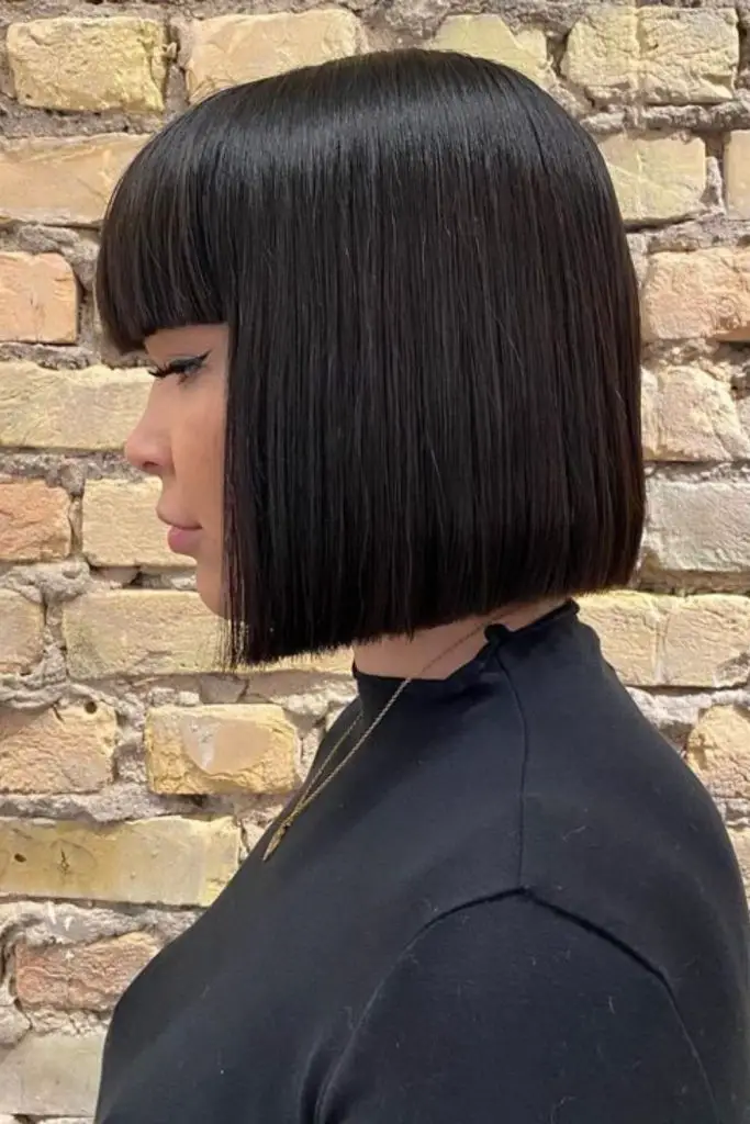 Straight-across blunt bob with tiny bangs.