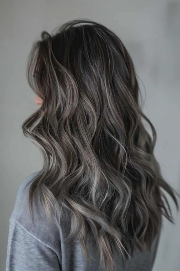 Charcoal ash waves with bright highlights.