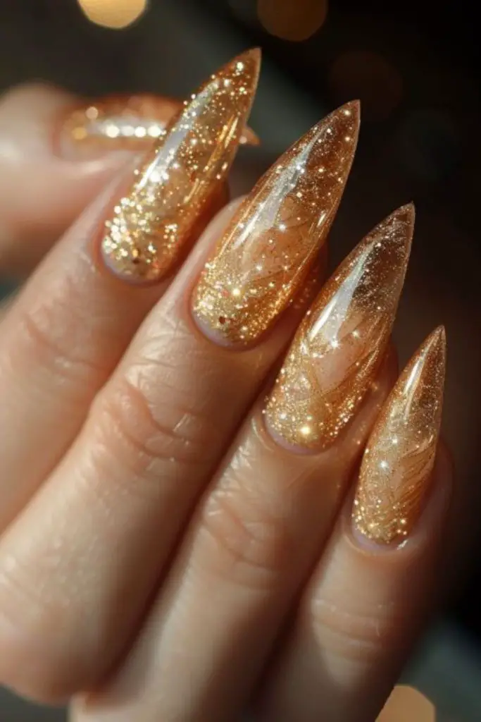Gold-tipped beige ombré nails.