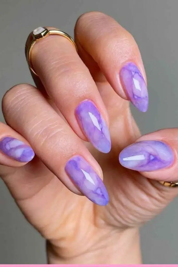 Lavender nails with white snowflakes.