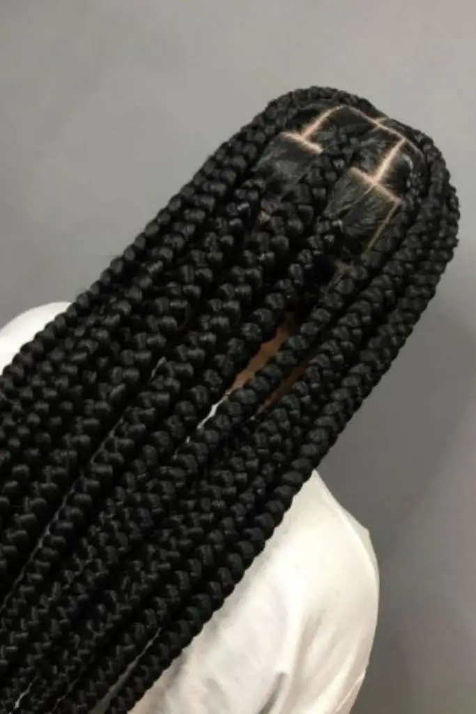 Cascading box braids with layered effect.