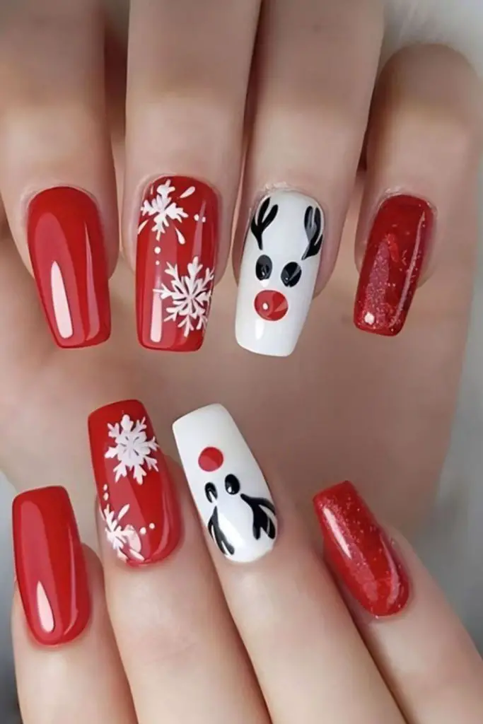 Red nails with white reindeer silhouettes.
