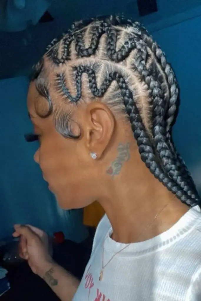 Braids creating serpentine patterns on scalp.