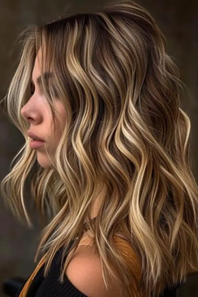 Subtle golden highlights over dark hair.