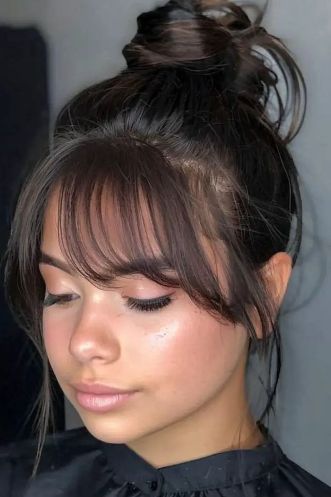 High bun adding height and sophistication.