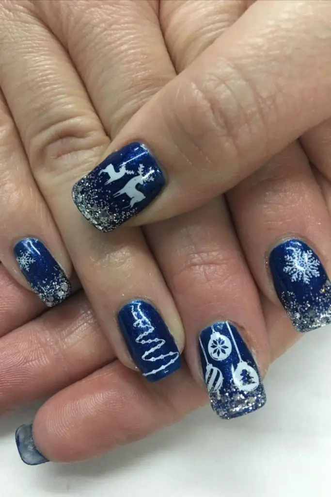 Blue nails adorned with silver deer.