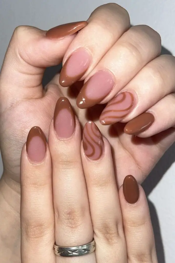 Caramel nails with latte swirl patterns.
