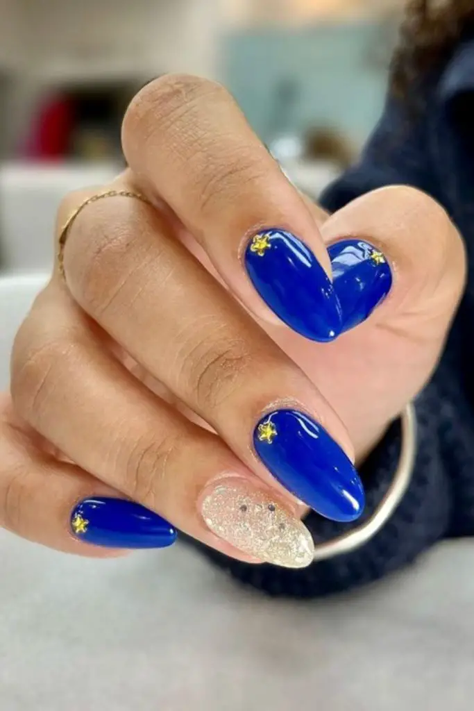 Cobalt blue nails with gold streaks.