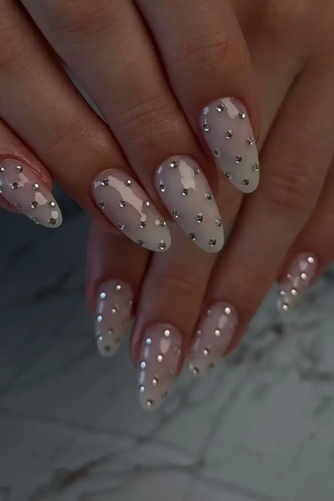 Elegant oval nails adorned with shimmering crystals.