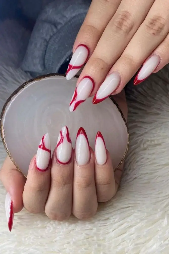 Nude nails with arrow-tip accents.