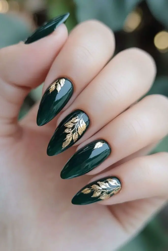 Emerald nails with gold forest-inspired details.