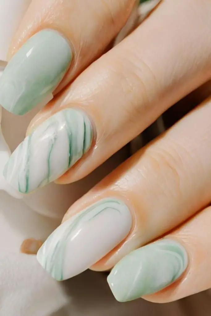 Frosted mint nails with wintery flair.