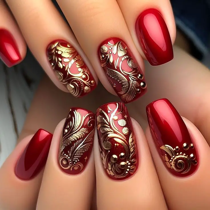 Red nails flecked with luxurious gold accents.