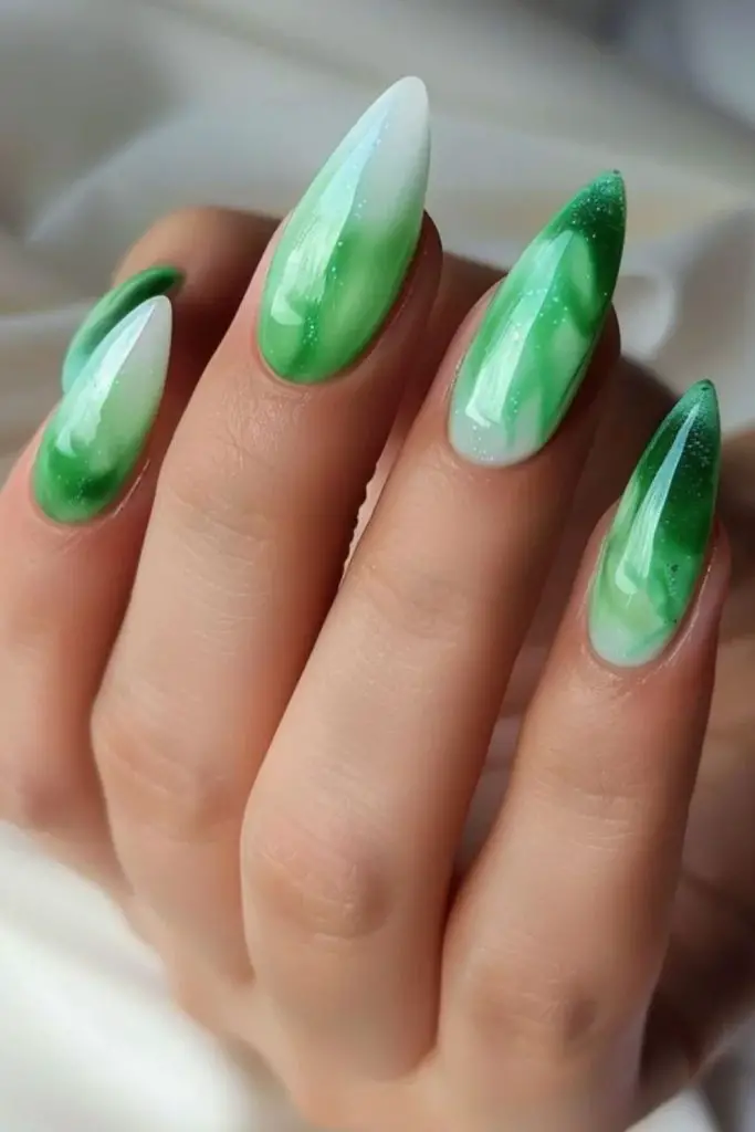 Jade green nails with white detailing.