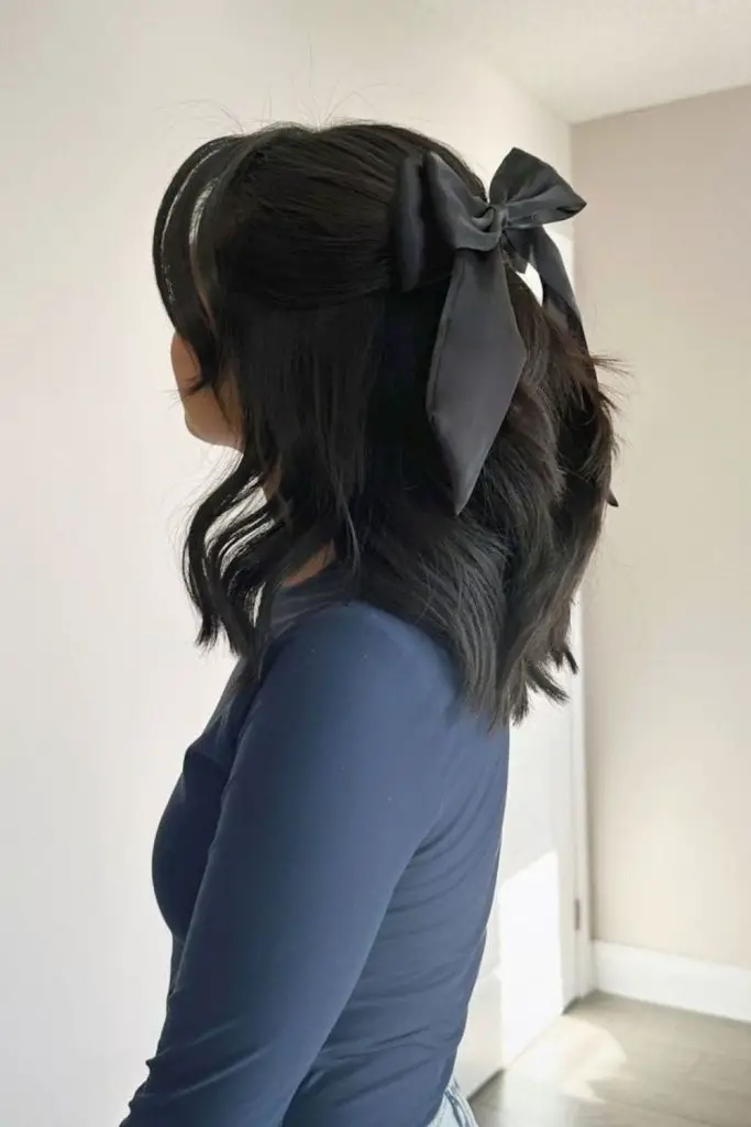 "Loose waves styled with a bow barrette."