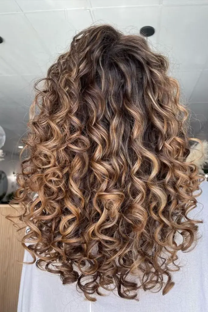 "Silky curls and vibrant color combination."