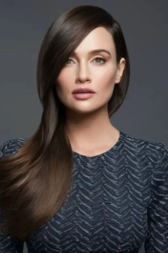 Side-parted sleek hair with volume.