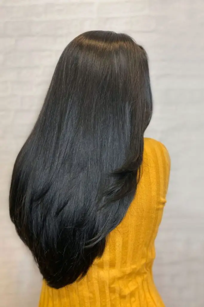 "Long layers with sleek, glossy silk press."
