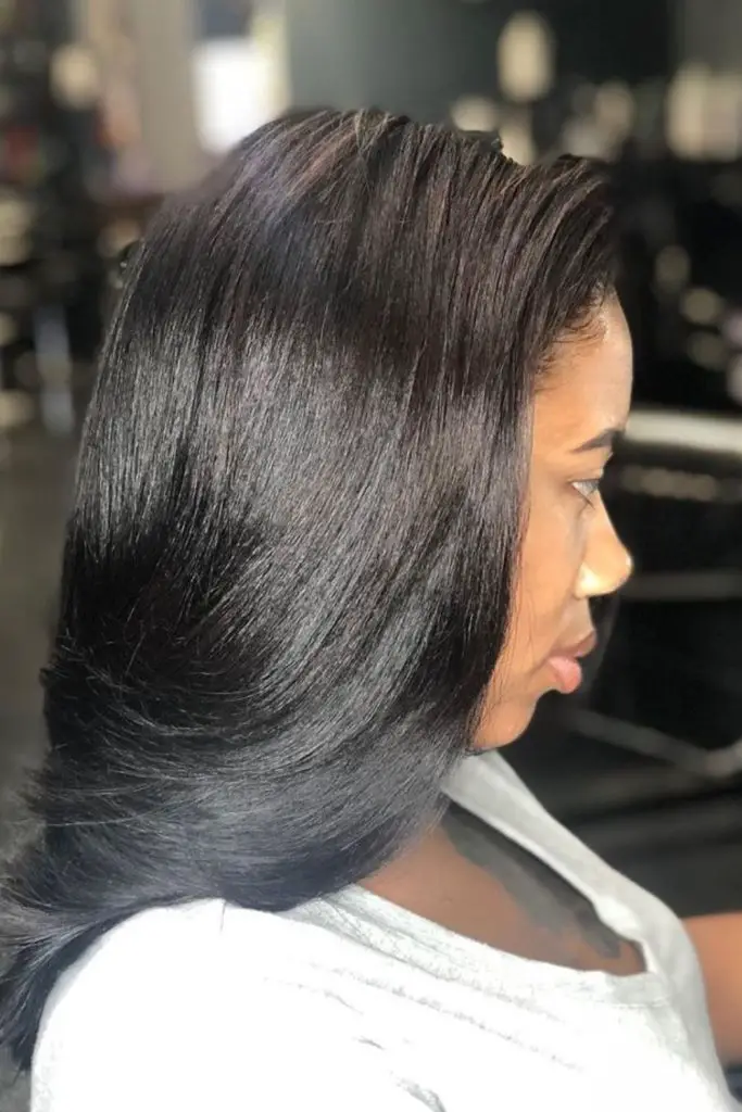 "Textured silk press with soft waves."