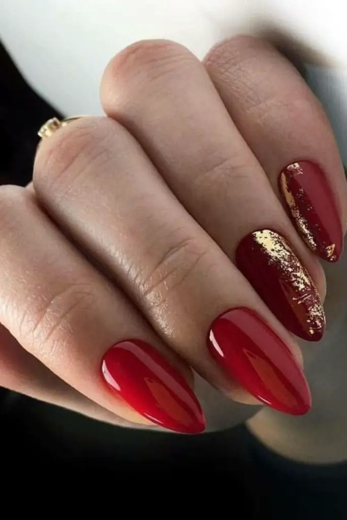 Matte burgundy nails with gold foil.