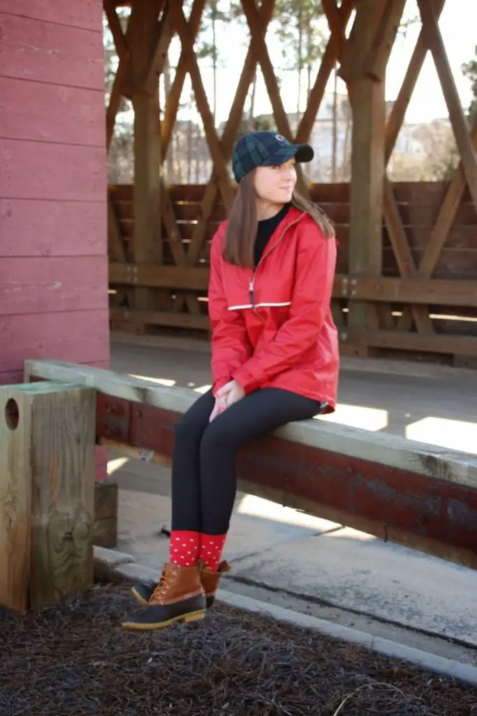 Vibrant raincoat brightens gloomy weather with style.