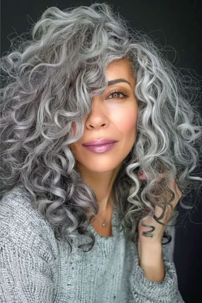 Vibrant bouncy curls enhanced with silver highlights.