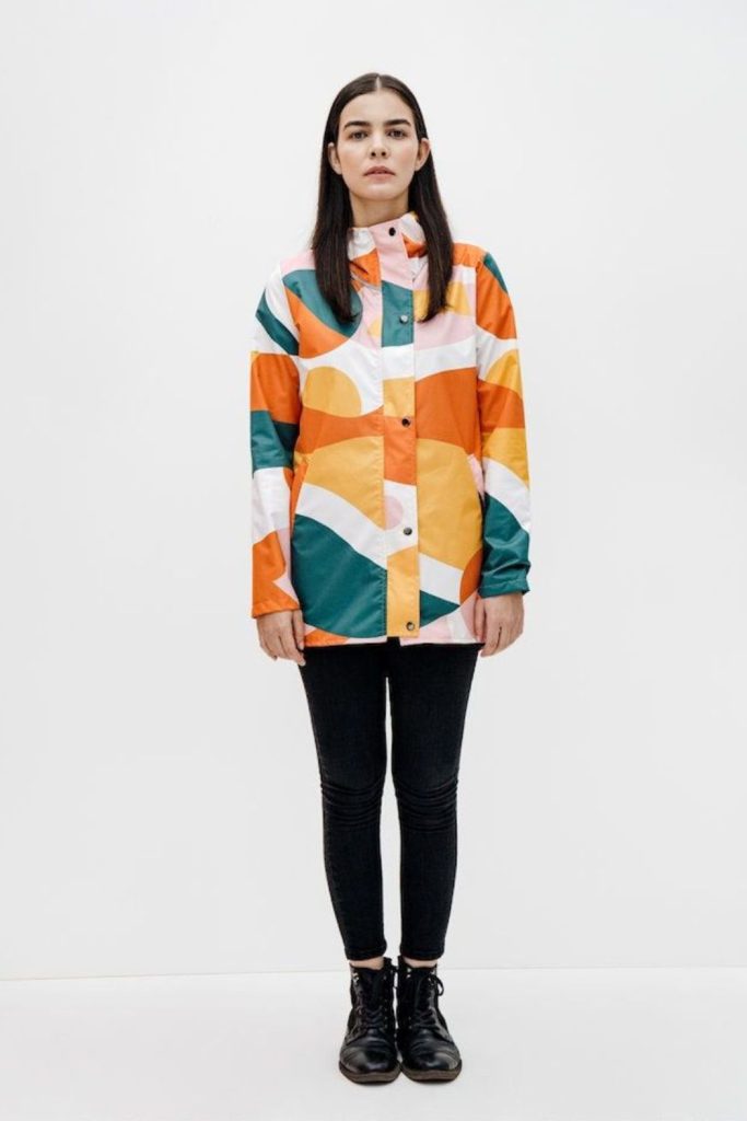 Color blocked raincoat creates a vibrant, dynamic look.