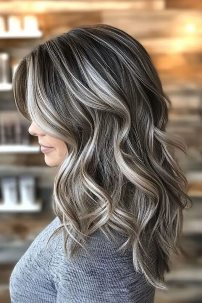 Soft ash-blonde highlights over silver hair.
