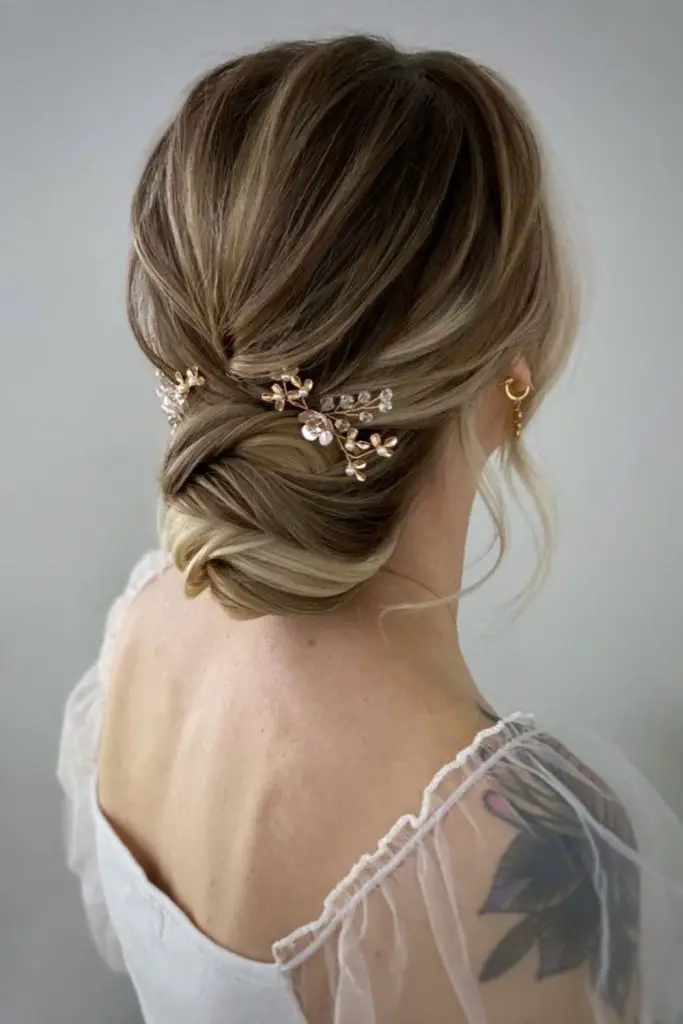 Sculpted chignon with delicate crystal pins.