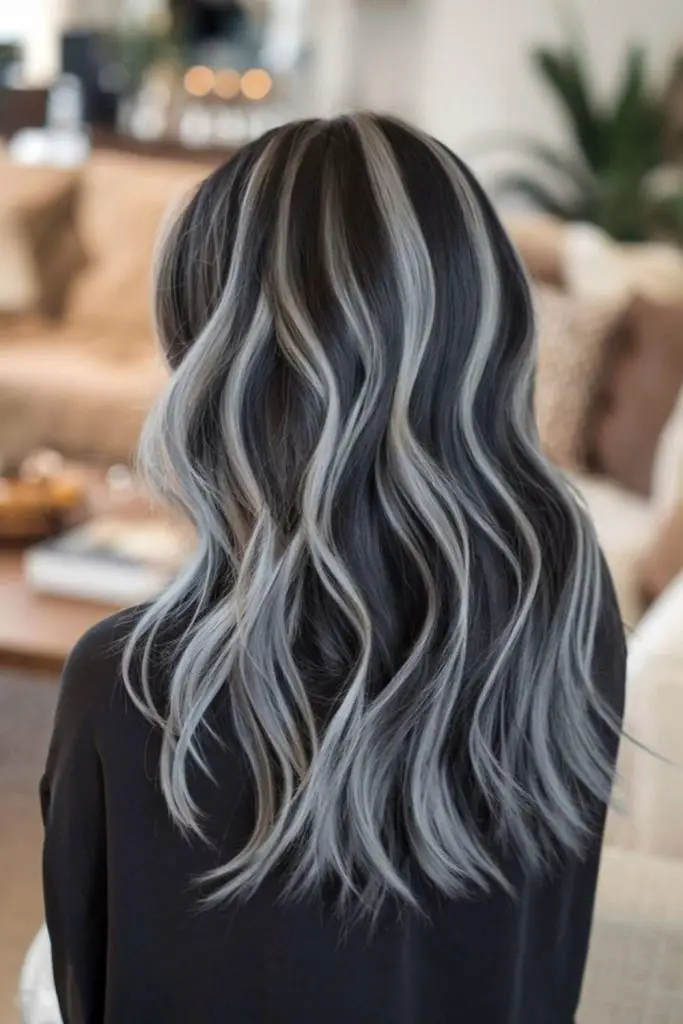 Thin platinum ribbons brightening silver hair.