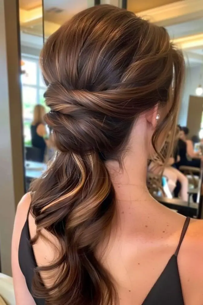 Twisted ponytail with soft cascading waves.