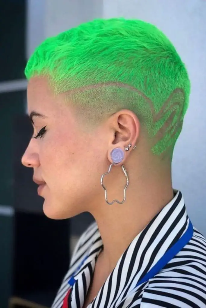 Green striped buzz cut with design.