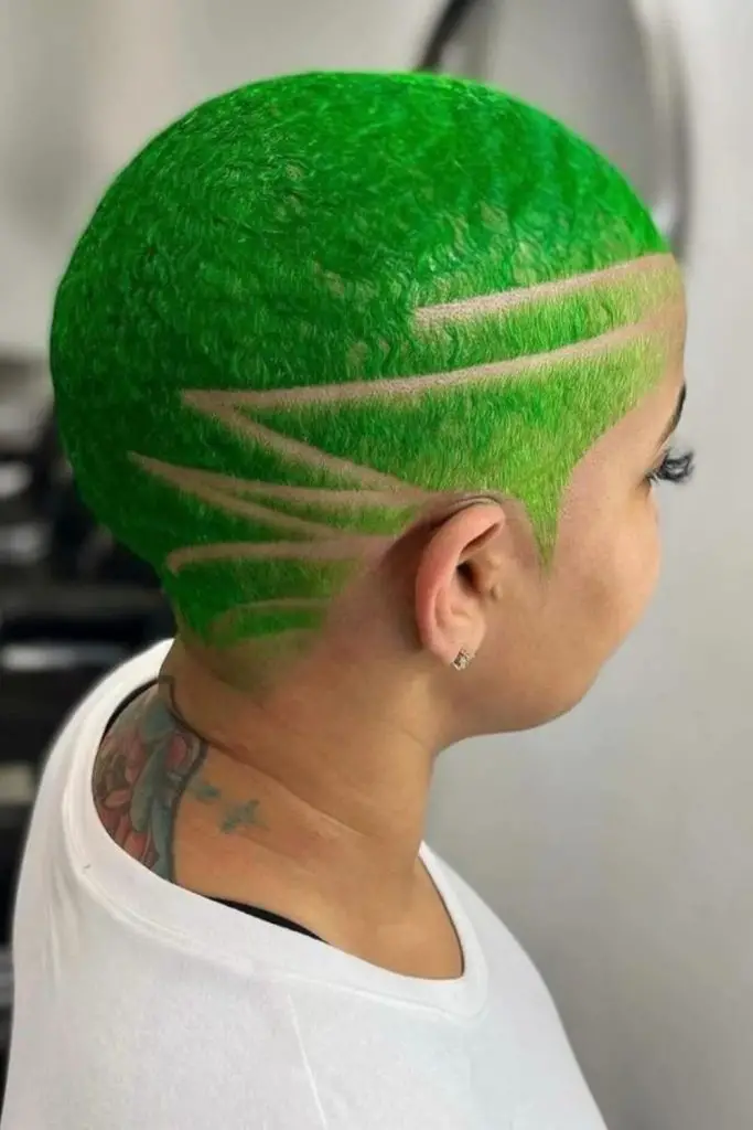 Green-toned subtle whisper buzz cut.