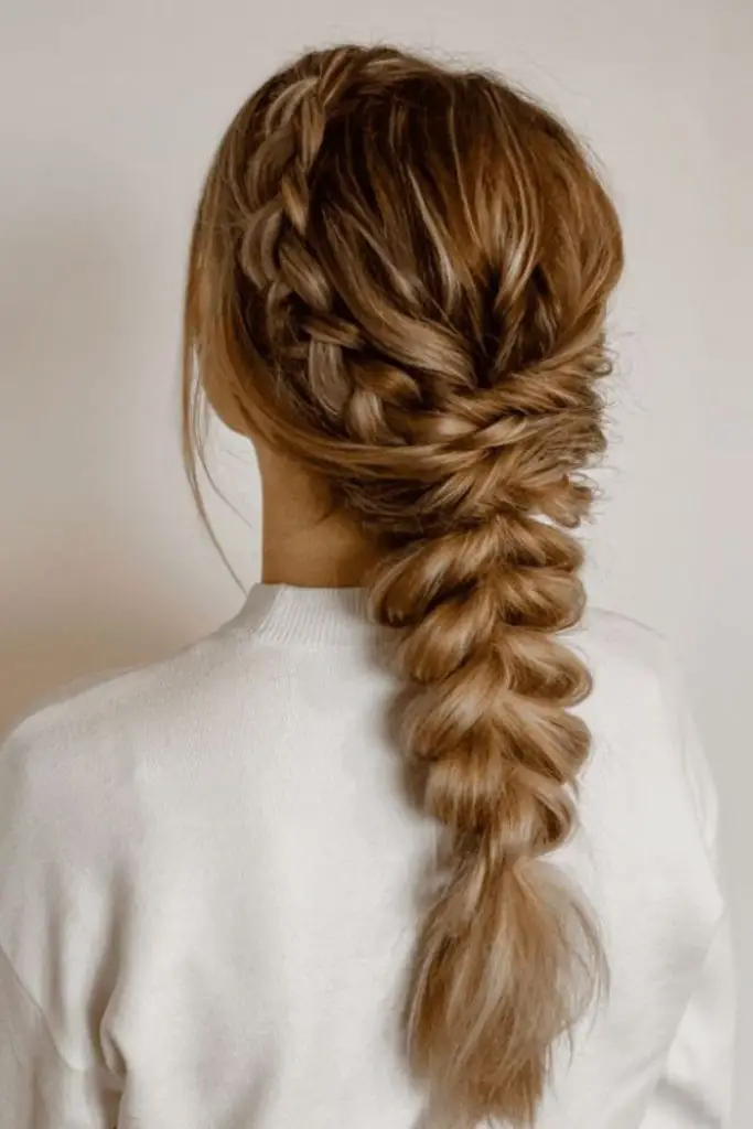 Chaotic whirlwind echoing fishtail braid.