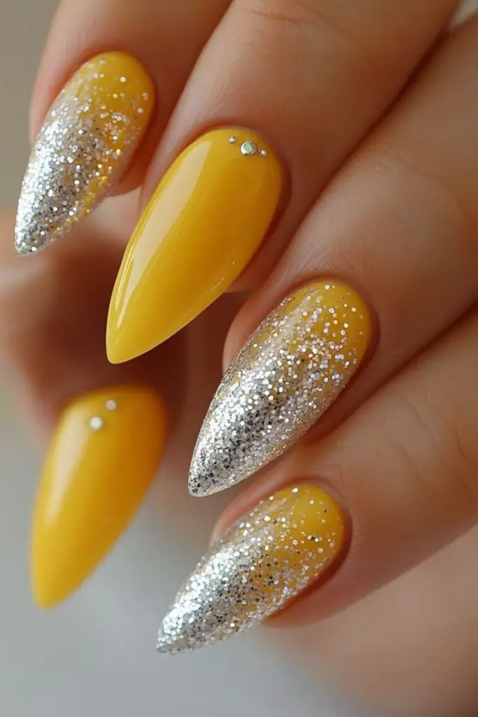 Gem-accented yellow nails with sparkle.