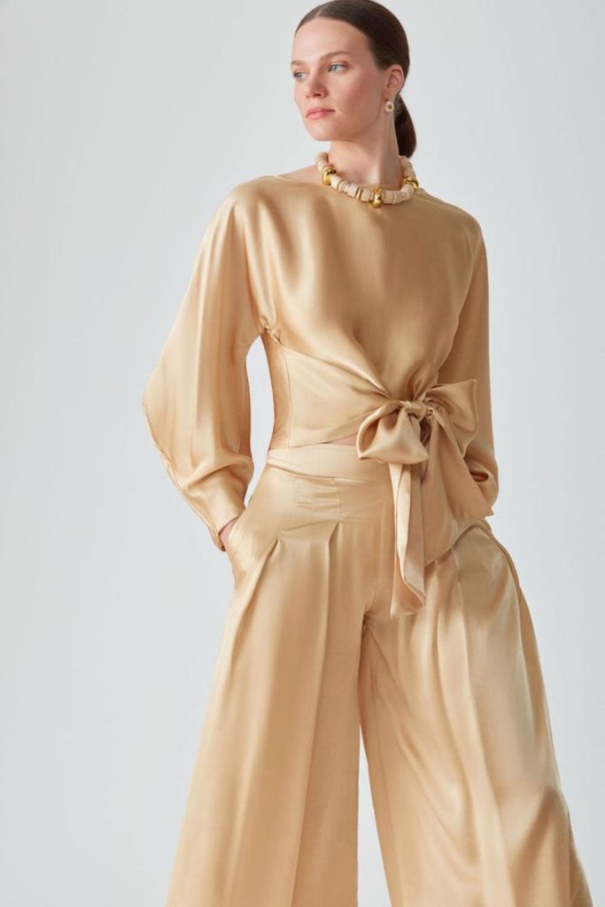 Silk knotted top with flared pants.