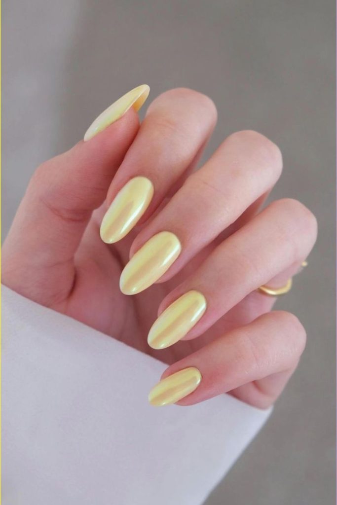Glossy corn silk yellow almond-shaped nails.